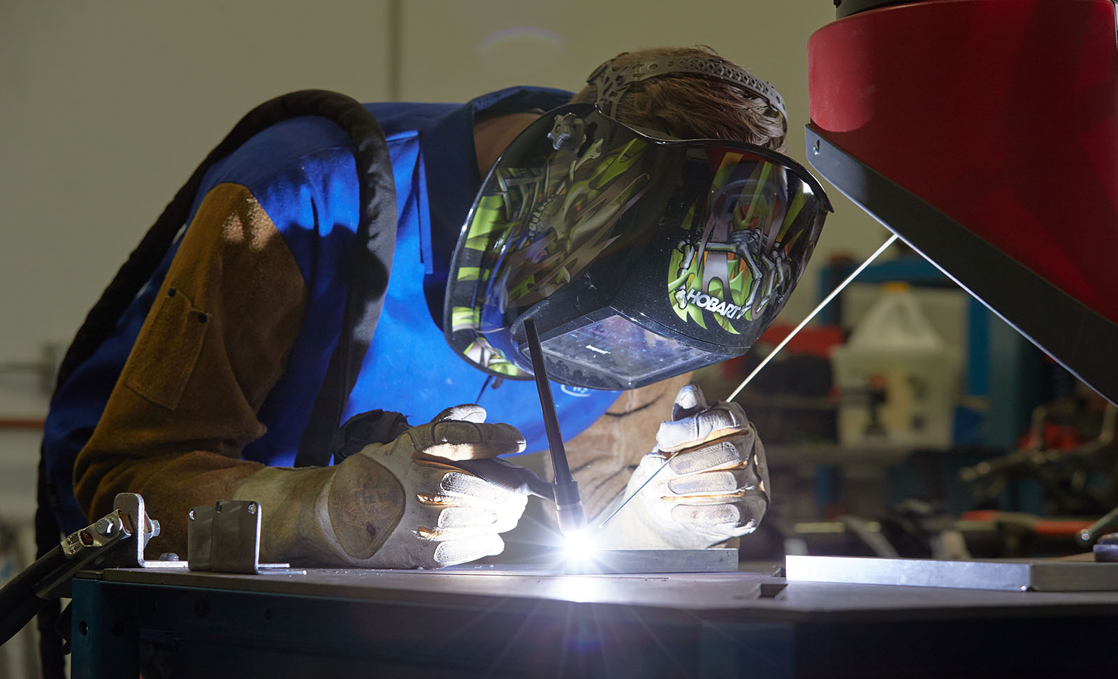 A Bernard Group employee welds metal frames for a custom display.