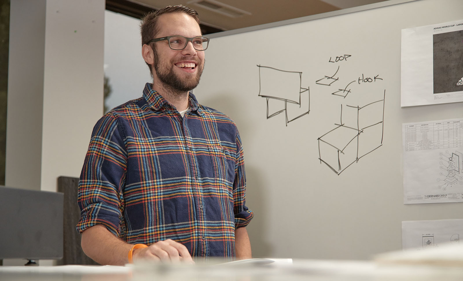 Designer from The Bernard Group sketches concepts on whiteboard