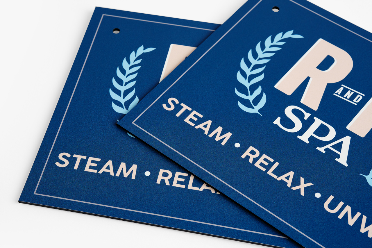 Two custom metal signs printed in blue and cream color with 