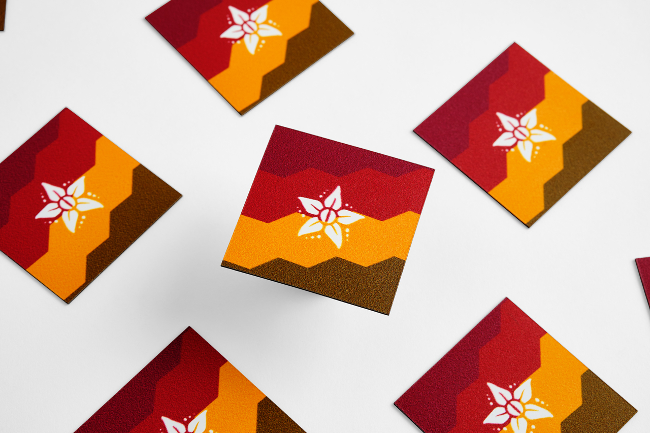 Six custom die-cut magnets printed with a red, yellow and brown design and a star in the middle.