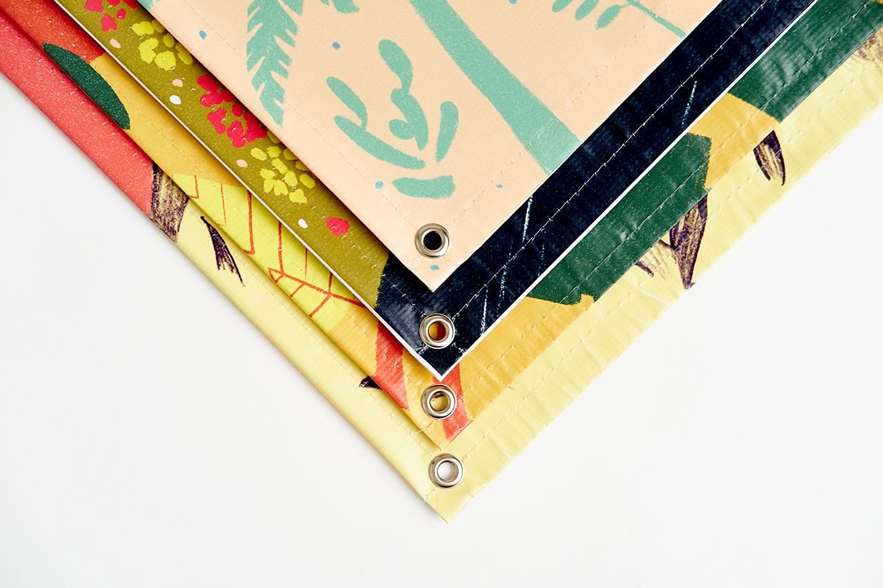 Four custom banners fanned out over each other with grommets in each corner.