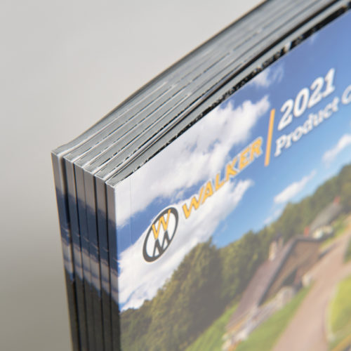 A stack of six product catalogs for Walker Mowers with perfect bindings.