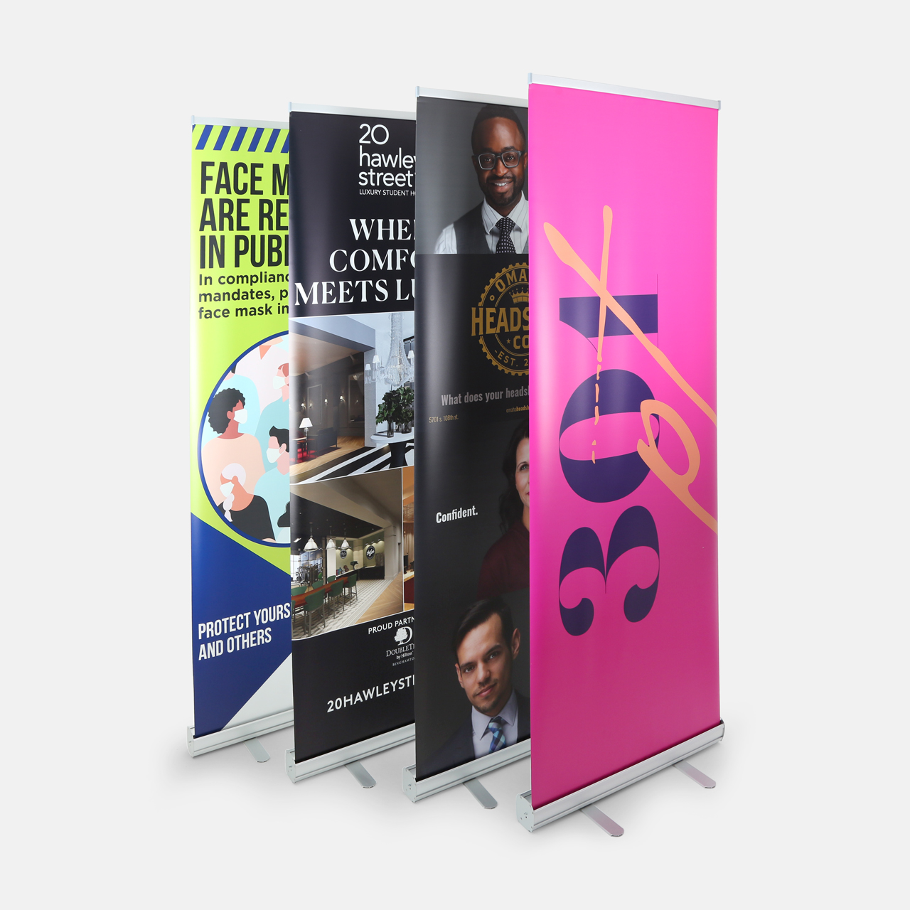 Four pop-up banners standing in a row with various designs and imagery.