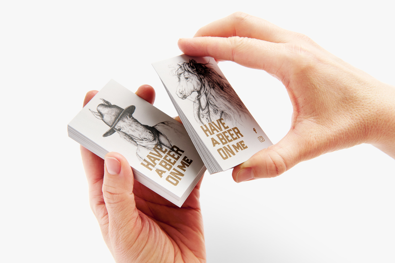 Two hands holding custom business cards printed with 