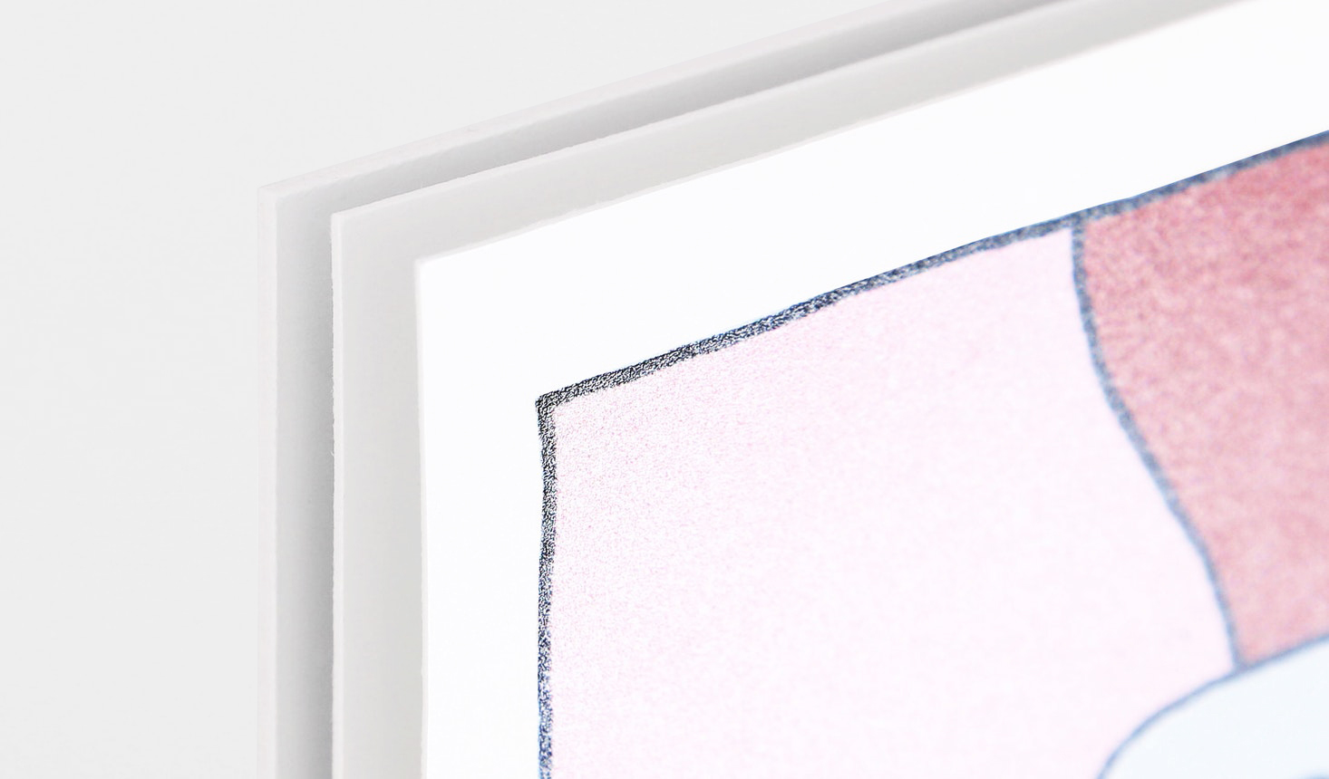 The corner of a cardstock sign with a pale pink and red design.