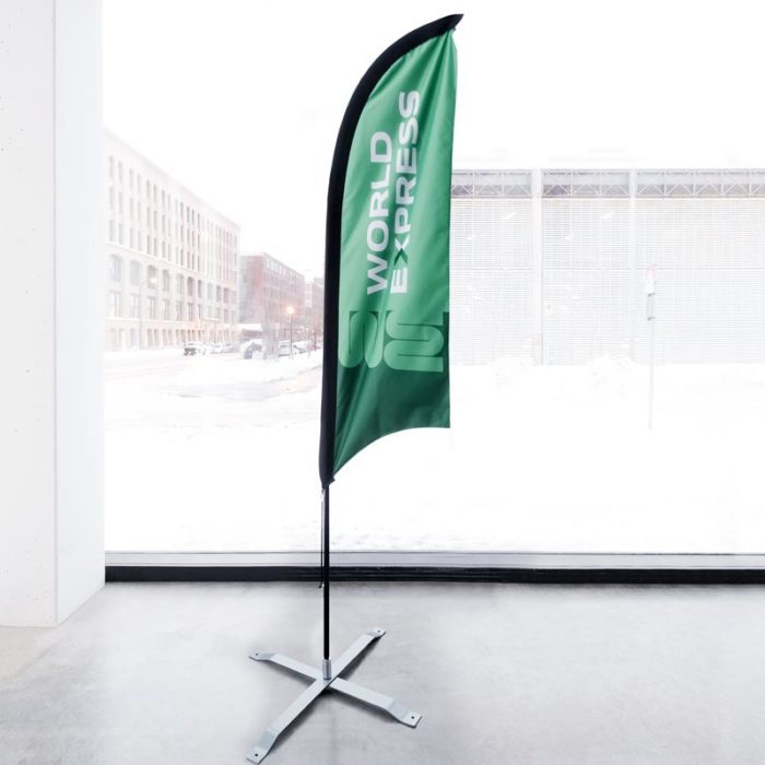 A trade show feather flag printed with a green design and 