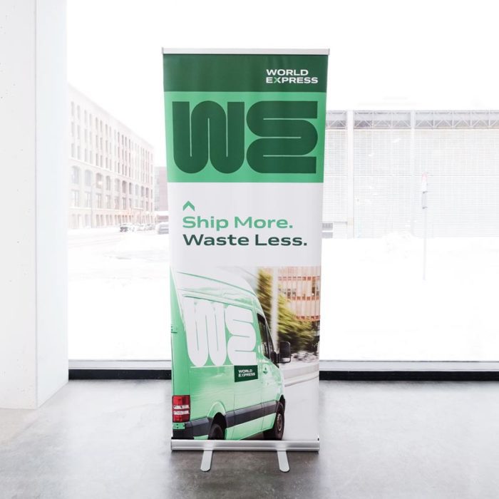 A trade show pop-up banner printed with a green design a 