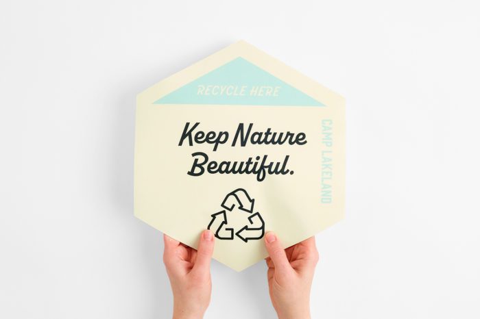 Two hands holding a custom floor graphic printed with "Keep Nature Beautiful."