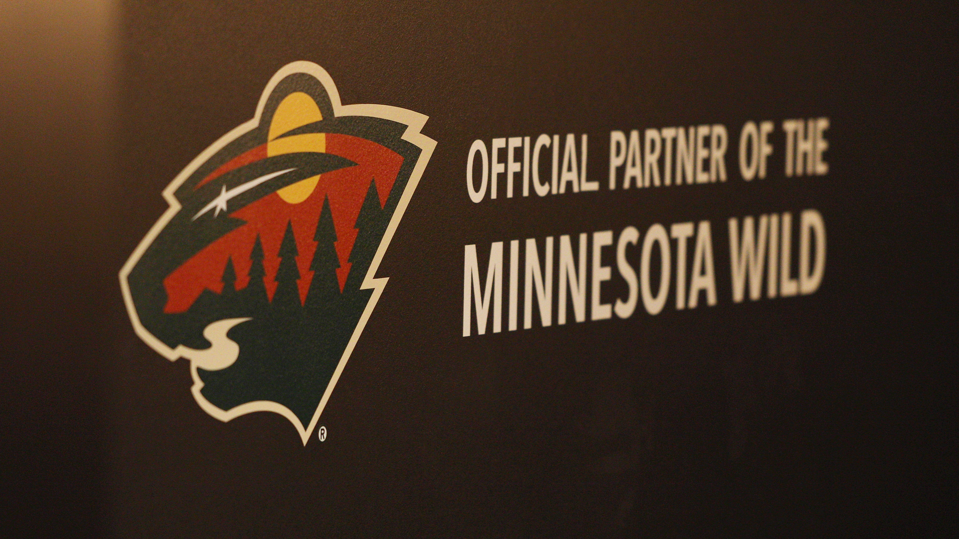 A custom wall decal with the Minnesota Wild logo and Official Partner of the Minnesota Wild printed in white.