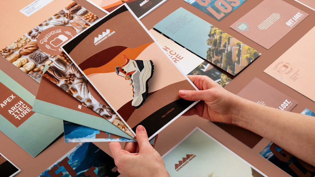 Two hands holding a catalog, self-mailer, brochure, and postcard using Mocha Mousse Pantone Color of the Year. 