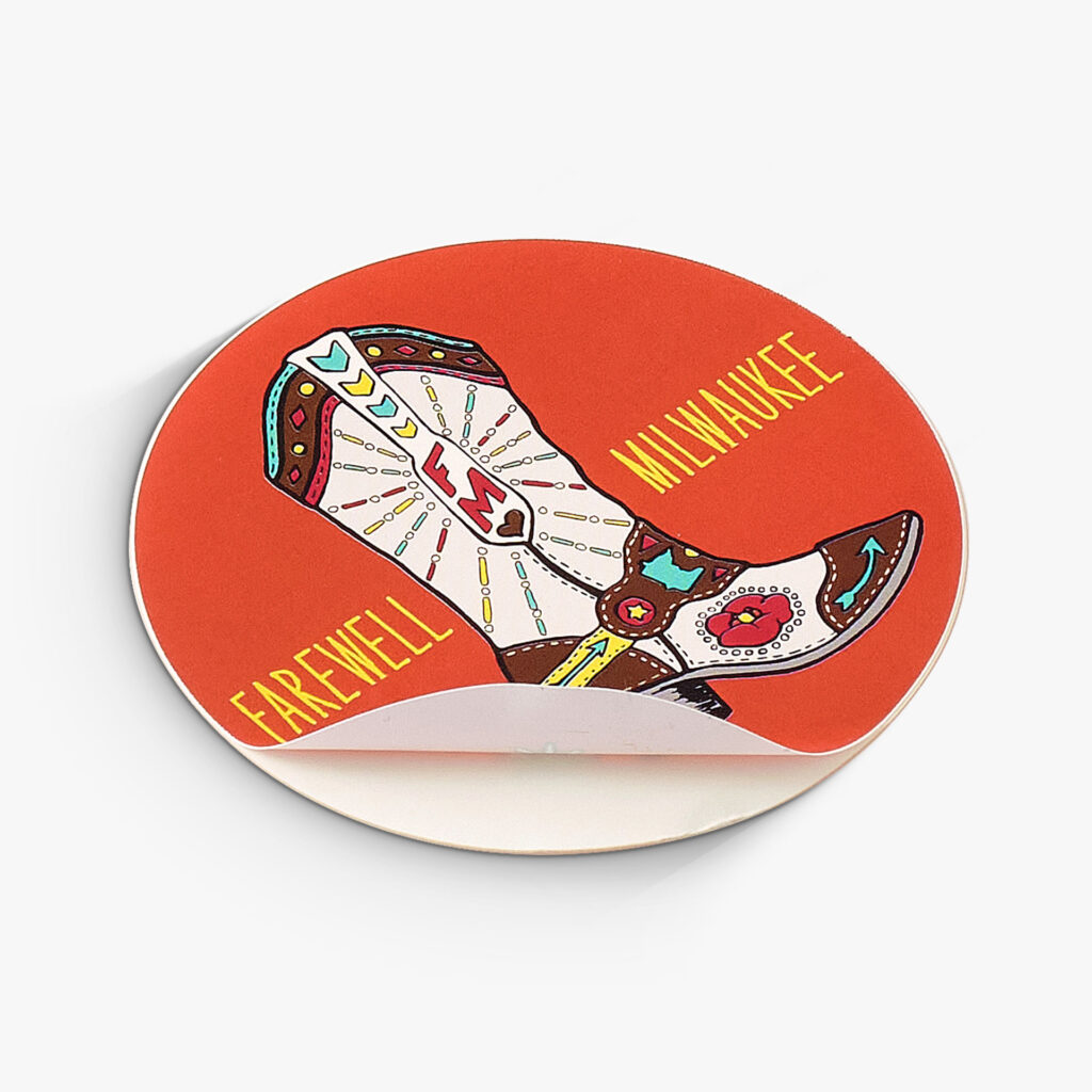 A custom sticker displaying farewell milwaukee with a decorative cowboy boot. The edge is peeling up to show its stickability.