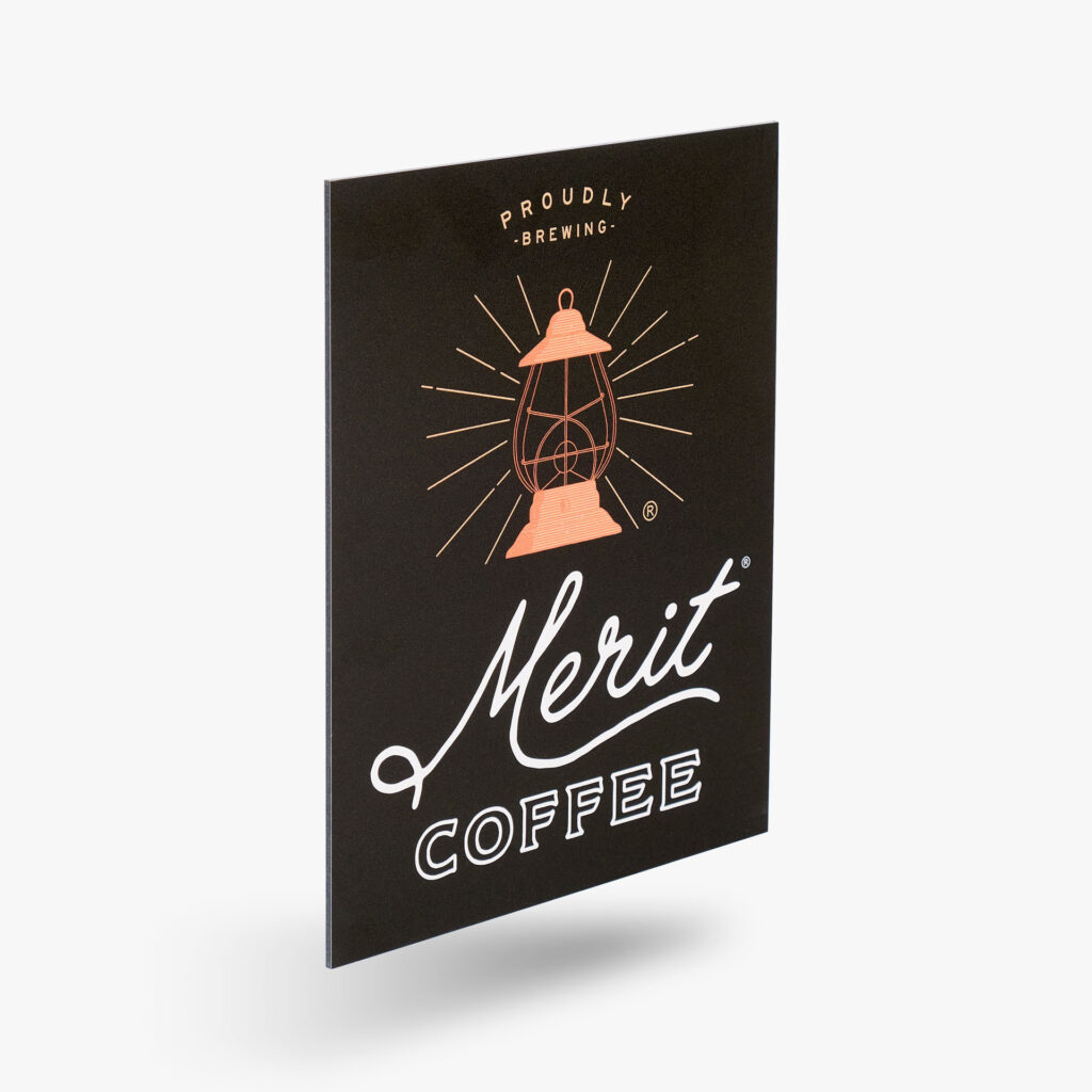 An aluminum sign featuring a lantern graphic and Merit Coffee.