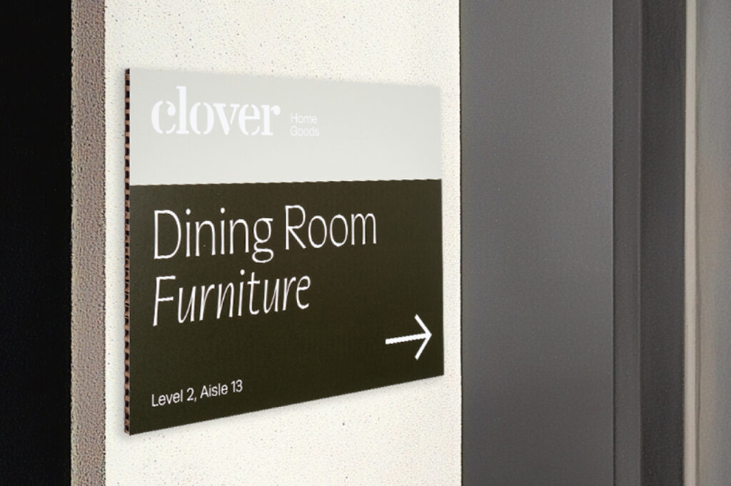 A business sign for Clover, showing the direction toward the Dining Room Furniture.