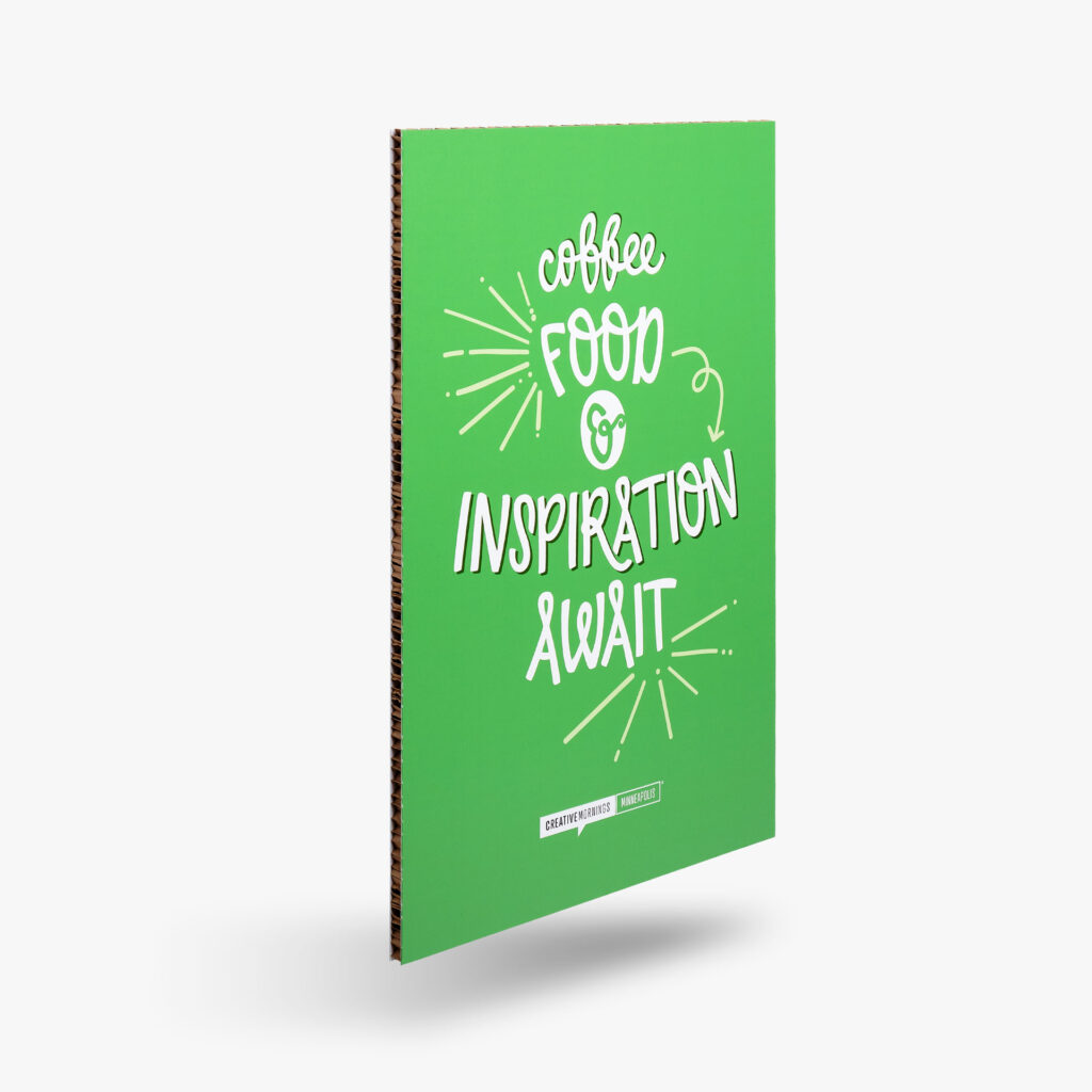 A sign with decorative typography stating "coffee, food, & inspiration await" for Creative Mornings. This signage reinforces the importance of considering the lighting and visibility.
