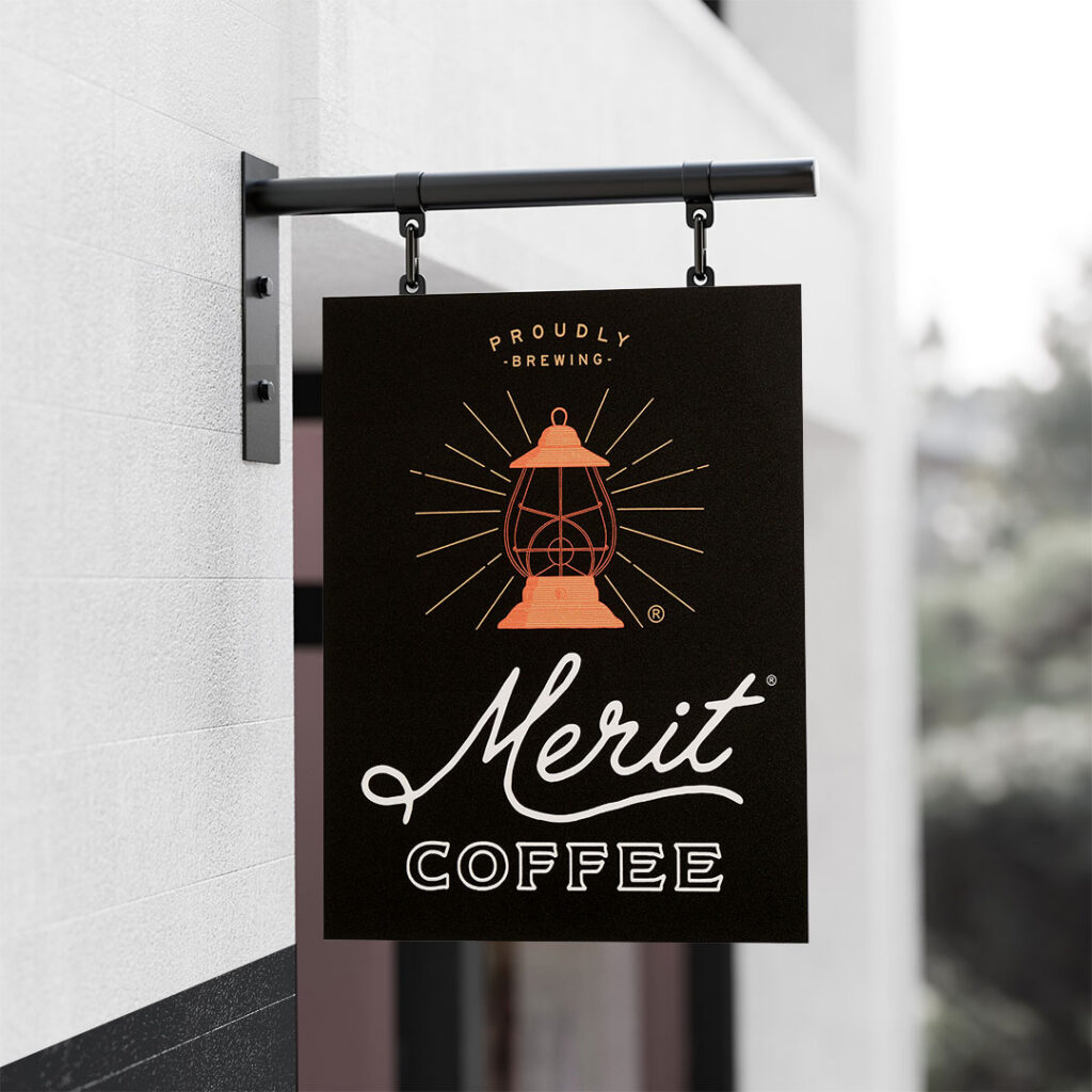 An aluminum sign printed with Merit Coffee and a lantern graphic in orange.