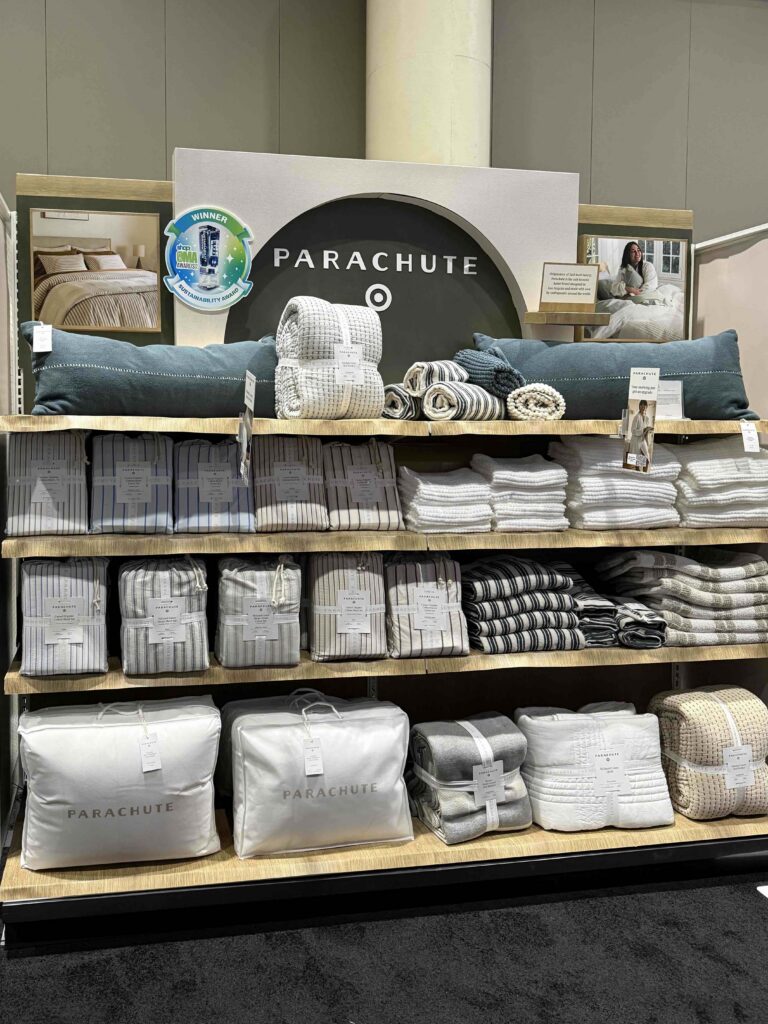 A recessed architectural arch in-line gondola retail display for Parachute Home bedding with floating shelves inside a Target store.