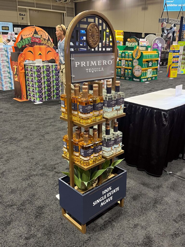 A laser-etched metal and wood architectural frame display featuring agave accents and a bottle of Lunazul Primero tequila.