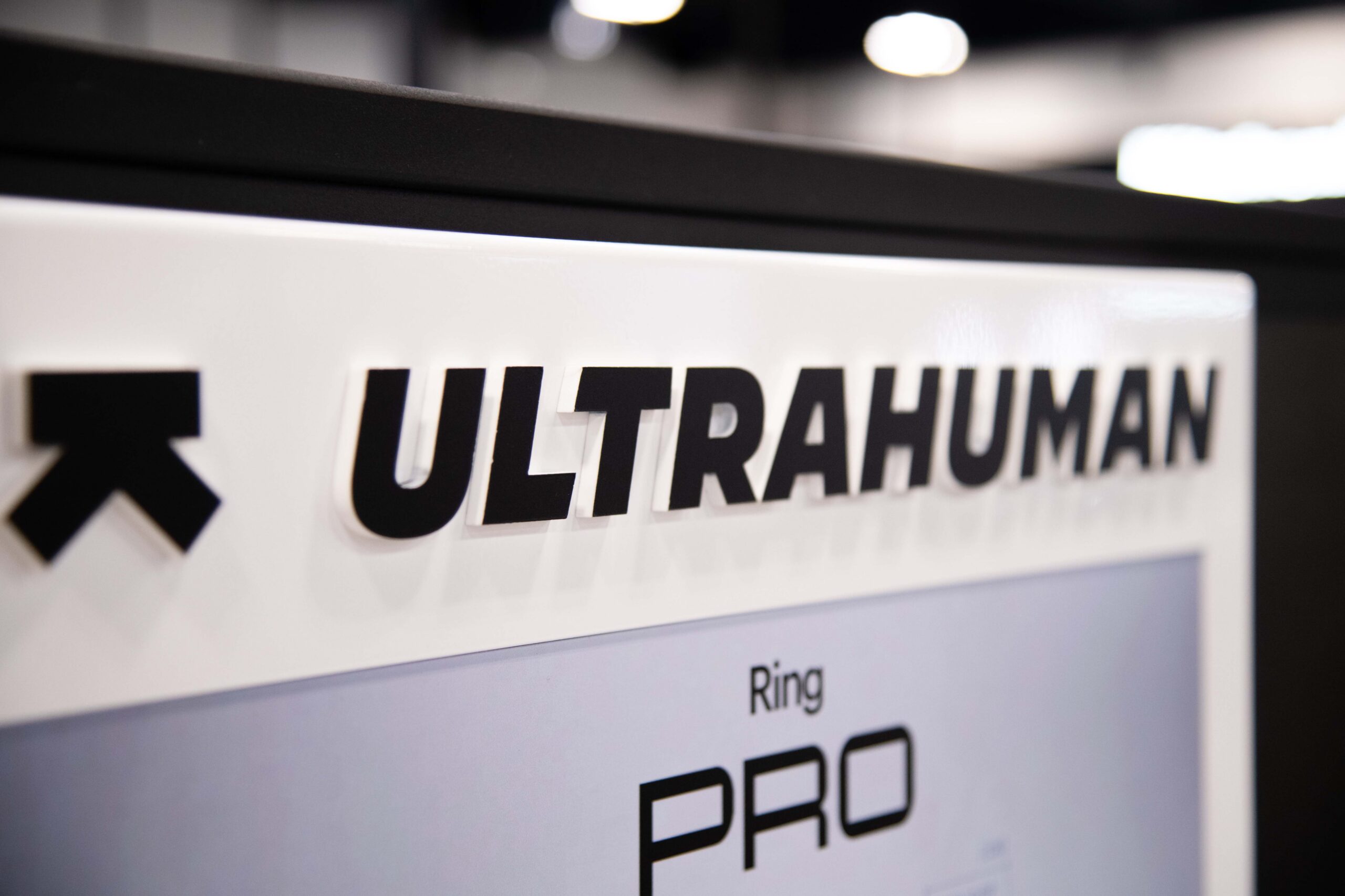 Close-up shot of the Ultrahuman logo and Ring AIR branding header on a custom retail display built by The Bernard Group.